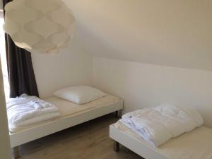 a room with two beds and a light fixture at DHH Claire_SAWO in Ostseebad Karlshagen