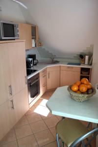 a kitchen with a bowl of oranges on a table at Fewo An der Duene 5b_BAER in Ostseebad Karlshagen