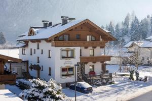 a house in the snow with at Landhaus Schneeberger in Mayrhofen