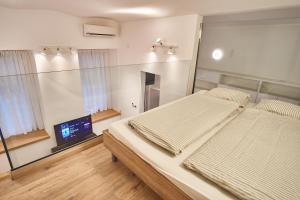 Posteľ alebo postele v izbe v ubytovaní V27 Apartment | hostAID