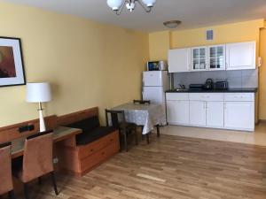a living room with a kitchen and a dining room table at Apartament EWA in Tarnów