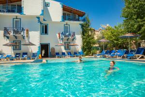 two people in the swimming pool of a hotel at Dove Apart Hotel in Fethiye