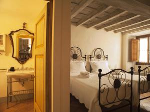 a bedroom with a bed and a sink and a mirror at Signoria apartment in Florence