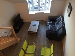 an overhead view of a living room with a table and chairs at Bel appartement vue sur mer in Cancale