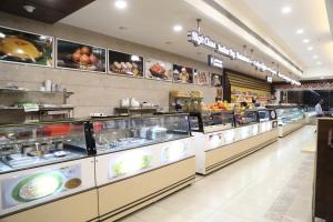 a food court with a bunch of food at The Palm Residency- Ariyanoor in Salem