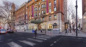 a city street with a building and cars on the street at Ambassadors Bloomsbury in London