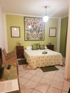 a bedroom with a bed and a painting on the wall at La Crota in Asti +52 photos