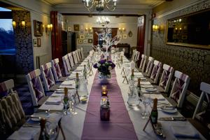 a long table in a room with a long table with chairs at Broadoaks Boutique Country House in Windermere