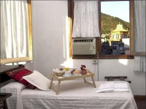 a bedroom with a bed with a table on it at Hotel Regidor in Salta