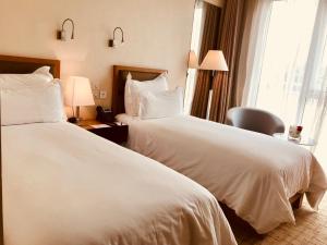 Ένα ή περισσότερα κρεβάτια σε δωμάτιο στο Pefaco Hotel Maya Maya