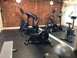 a gym with several exercise bikes and a brick wall at Penn's View Hotel Philadelphia in Philadelphia