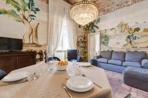 a dining room with a table and a blue couch at Palazzo Giorgioli Apartment in Rome