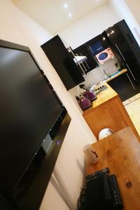 a view of a kitchen with a large screen television at The Lookout in Helensburgh