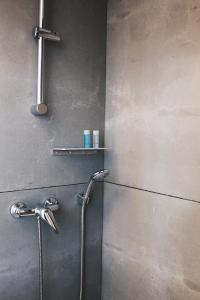 a shower in a bathroom with a shower head at Lost Apartments in Porto +64 photos