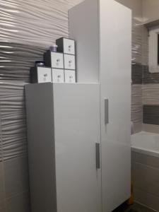 a white cabinet in a bathroom with a sink at Apartment GoodMood in Split +32 photos
