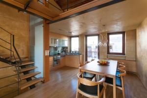 a kitchen and dining room with a wooden table and chairs at Dorotheou House in Chania