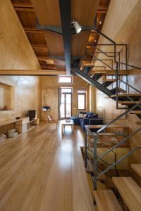 a living room with a spiral staircase in a loft at Dorotheou House in Chania