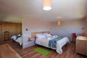 a large bedroom with two beds and a couch at Hotel Ilaia in Punta Arenas
