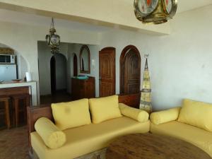 a living room with a couch and a kitchen at Taghazout Beach in Taghazout