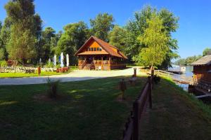 a log cabin in a park next to a fence at Apartmani Anna in Sveti Martin na Muri
