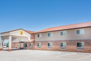 a hotel with a building with a parking lot at Super 8 by Wyndham Ogallala in Ogallala