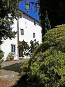 a large white building with trees in front of it at Agriturismo Il Palazzaccio in Galliano