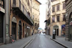 an empty street in a city with buildings at Apartment Tornabuoni in Florence