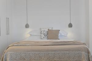 a bed with two pillows on top of it at Apollon Boutique Hotel in Parikia