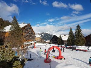 安哲雷的住宿－Holidays Groupes Anzère，一群人在滑雪胜地的雪中玩耍