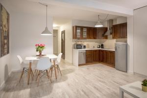 a kitchen and dining room with a table and chairs at Bed4You in Zielona Góra