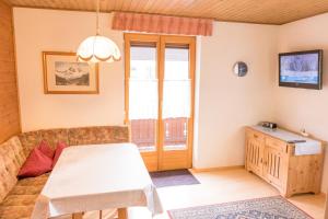 a living room with a couch and a table at Landhaus Alpenrose in Mayrhofen
