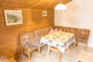 a living room with a table and a couch at Landhaus Alpenrose in Mayrhofen