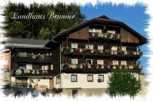 a building with flower boxes on the side of it at Pension Brunner in Bad Kleinkirchheim