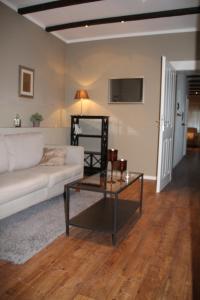 a living room with a white couch and a table at Apartment in Alt-Stadt Köpenick in Berlin