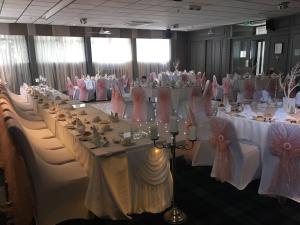 a room filled with tables and chairs filled with food at Crookston Hotel in Glasgow