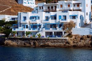 a group of white houses on a hill next to the water at Vithos Seaside Aparthotel in Astypalaia