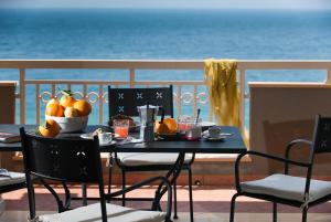 a table with a bowl of fruit on a balcony at Casa Vacanze Samira in Fondachello +65 photos