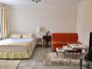 a bedroom with a bed and a table at Puerto marina in Benalmádena