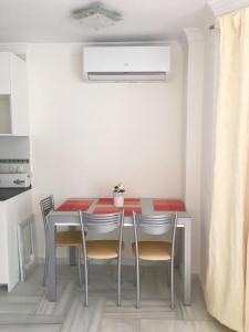 a kitchen with a table and chairs in a room at Puerto marina in Benalmádena