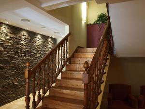 a staircase in a building with a stone wall at Hotel Valle De Izas in Sallent de Gállego