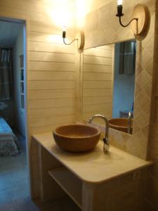 a bathroom with a bowl sink on a counter at La Guéritaulde in La Tour-dʼAigues