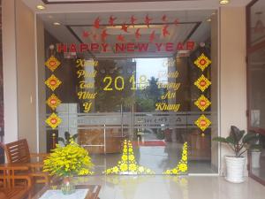 a store front with a happy new year sign in the window at Co Ba Vung Tau Hotel in Vung Tau