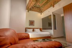 A bed or beds in a room at Java Village Resort by HOMEE Yogyakarta