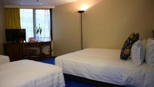 A bed or beds in a room at The Kimberley Hotel