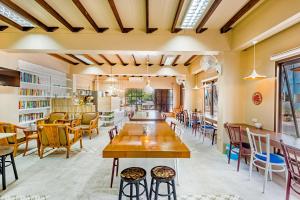 a room with tables and chairs and a library at Pure Phuket Residence in Phuket