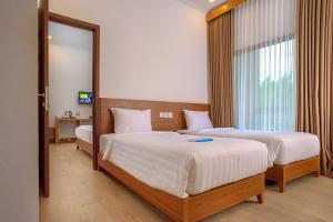 Postel nebo postele na pokoji v ubytování Java Village Resort by HOMEE Yogyakarta + 34 fotografií