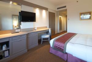 Ένα ή περισσότερα κρεβάτια σε δωμάτιο στο Sunway Hotel Hanoi
