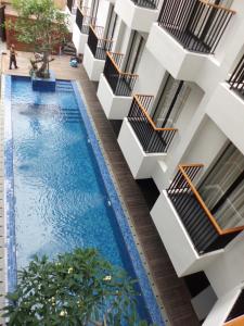 an overhead view of a swimming pool in a building at Ping Hotel Seminyak Bali in Seminyak