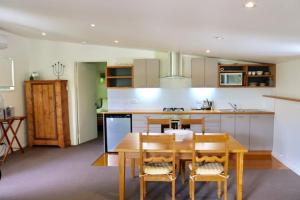 a kitchen with a wooden table and chairs in it at Bright Woodlands Retreat in Bright