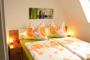 a bedroom with a bed with pillows on it at Appartement Neusiedl am See mit Dachterrasse in Neusiedl am See